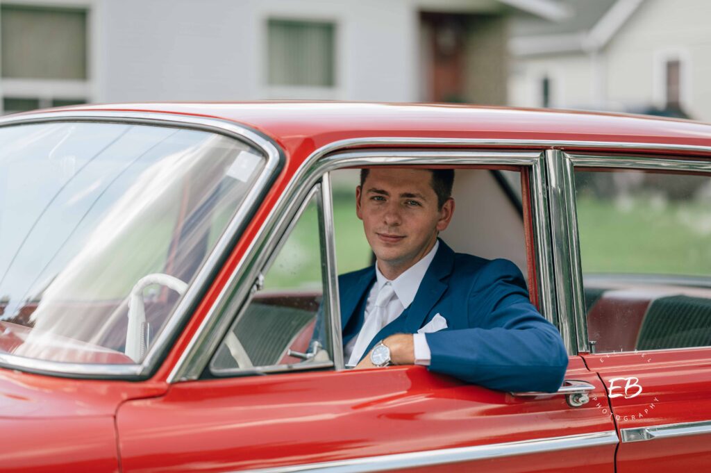groom  in  a red sports car